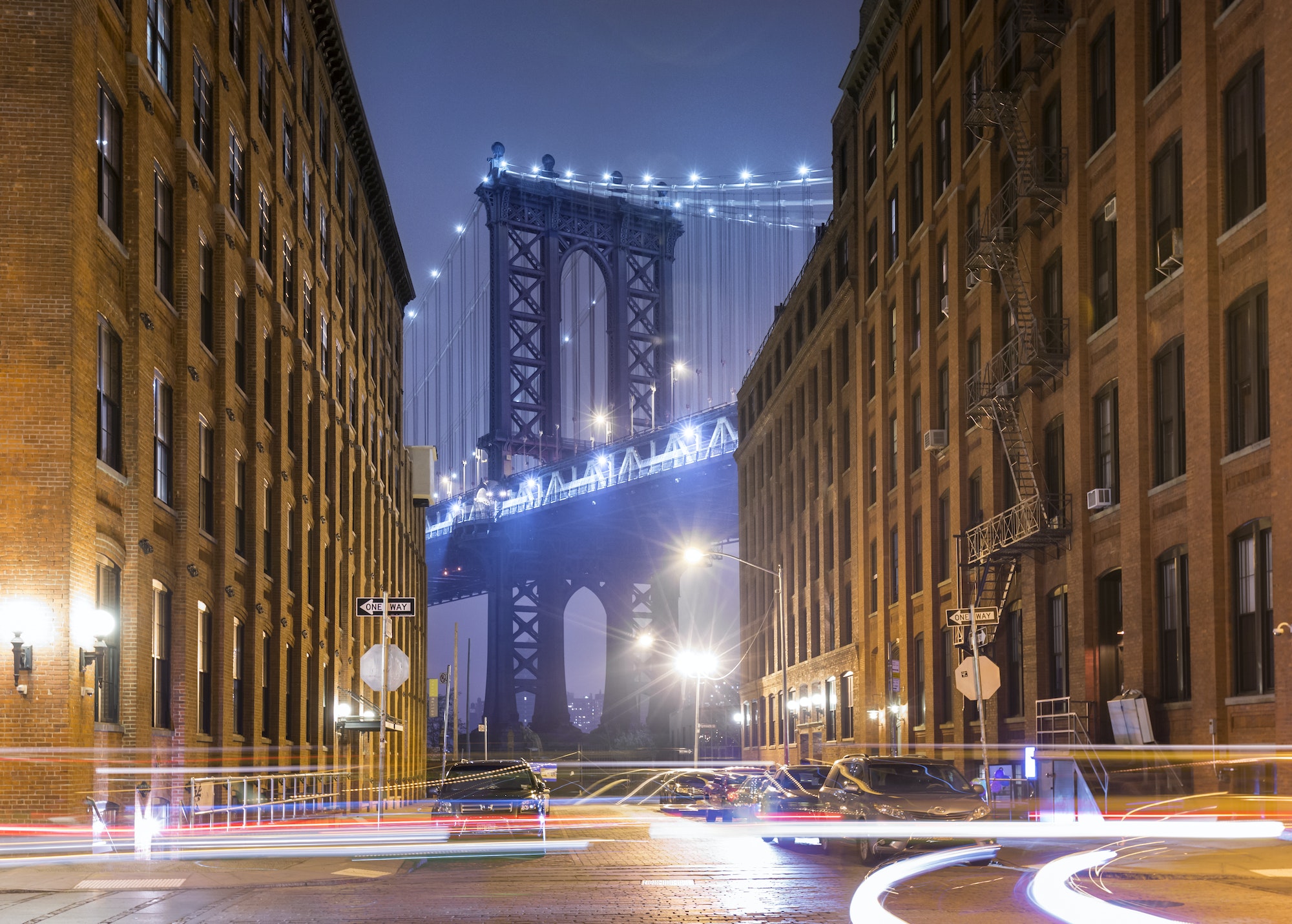 Manhattan Bridge and city apartments at night, New York, USA